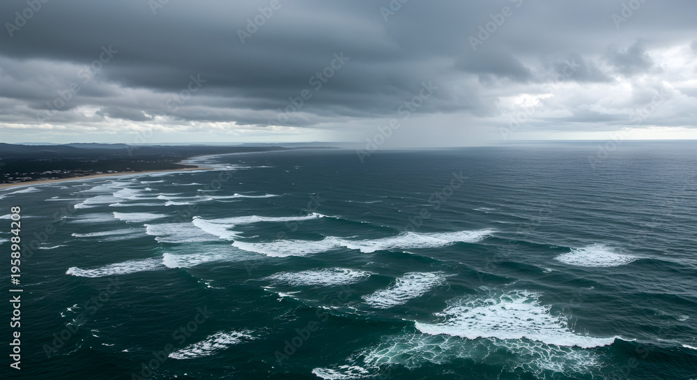 Fototapeta premium Expansive Ocean Waves Under Gloomy Sky with Stormy Clouds Approaching the Coastline and Rippled Water Surface
