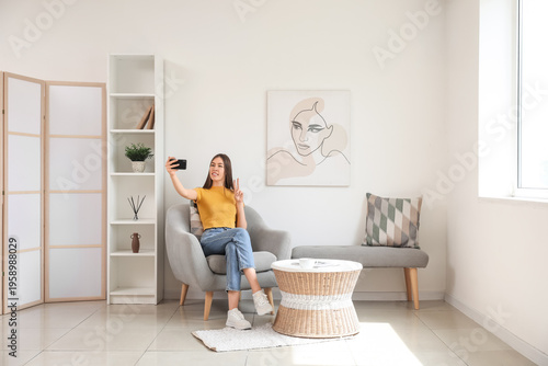 Young woman taking selfie w...