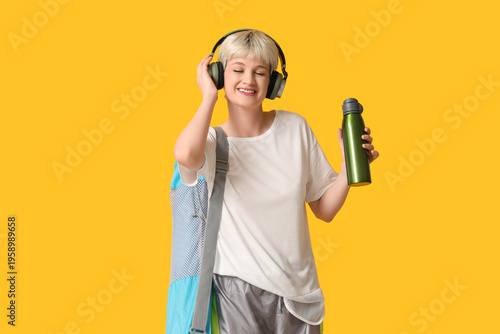 Sporty young woman with yog...