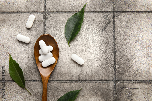 Spoon with pills and leaves...
