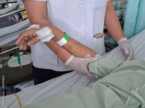 Position the arms or assist with physical therapy/joint mobilization for patients lying in a hospital bed.