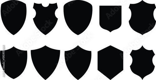 A set of black shield silhouettes in various shapes and designs, forming a concept for protection and security in a vector line art style.