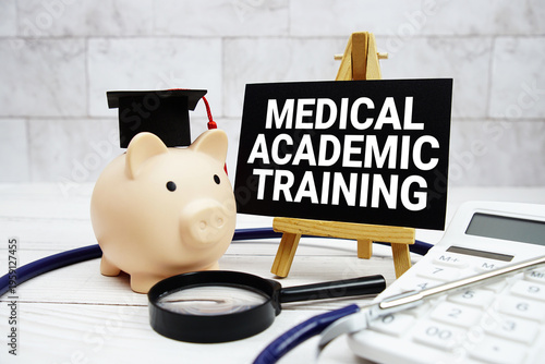 Medical Academic Training text with mortarboard, piggy bank, calculator, magnifying glass and stethoscope