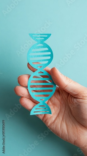 Paper DNA helix held in hand genetics research concept