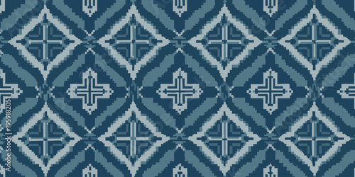 A close-up view of a blue and white patterned tile design showcasing geometric shapes and symmetry in a decorative arrangement.