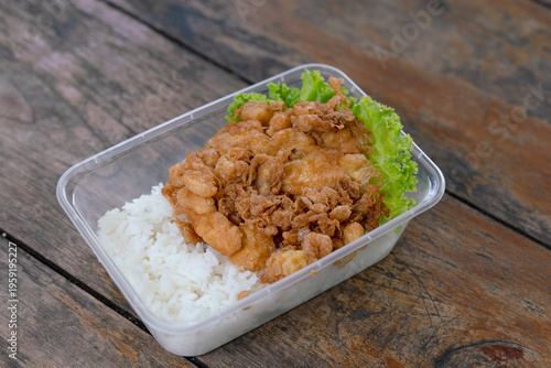 Omelette served with rice in a plastic container. Street food
