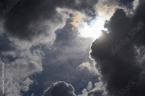 Fotografie Dark clouds part to reveal bright sun