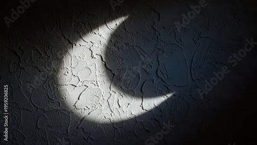 A profoundly dramatic and mysterious abstract textured plaster wall, rendered in deep shadows with a striking crescent moon shape brilliantly illuminated by a sharp, directional beam of light,