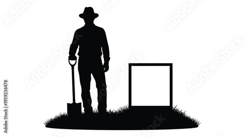 A silhouette of a man standing beside a grave with a shovel