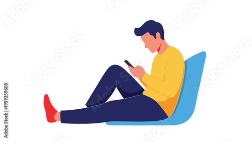 Relaxed man sitting on the floor and leaning against a blue bean bag chair while browsing social media on his mobile phone.