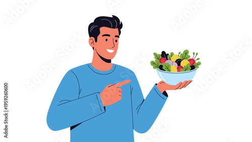 Happy young man pointing at a healthy bowl of fresh mixed salad he is holding to promote nutritious eating and a fit lifestyle.