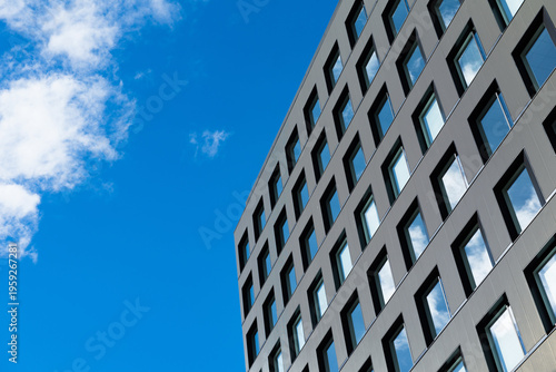 Modern glass buildings with reflection of cloud and blue sky background. Business skyscrapers in the Financial District, Sendai Downtown.