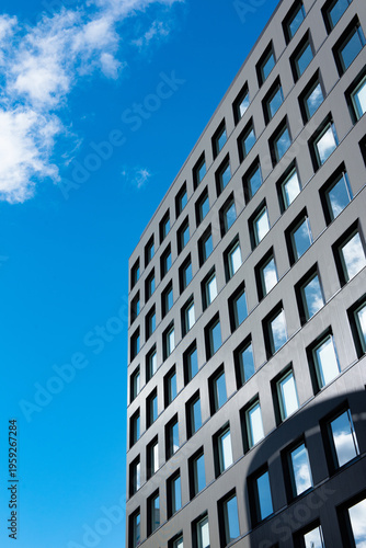 Modern glass buildings with reflection of cloud and blue sky background. Business skyscrapers in the Financial District, Sendai Downtown.