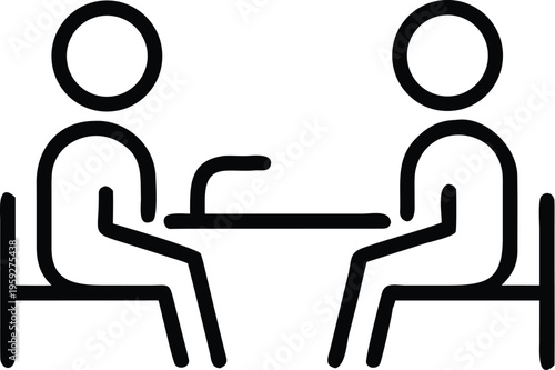 Two individuals engaged in a conversation over a table