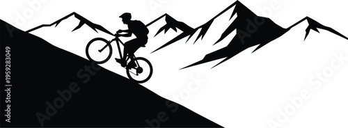 Silhouette of a mountain biker riding down a steep jagged slope