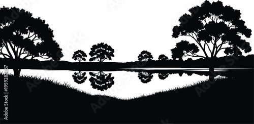 Silhouetted trees reflected in calm water at sunset or dusk