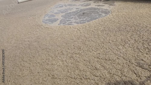 Gas bubbles and foam on the surface of the aeration process ponds in a wastewater treatment plant