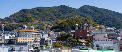 Foto Urakami Cathedral viewed from a hill with mountains