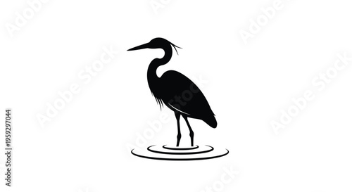 A graceful heron stands in water a striking black silhouette