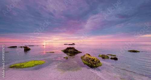 Beautiful cloudscape over the sea waves and rocky beach  sunrise video