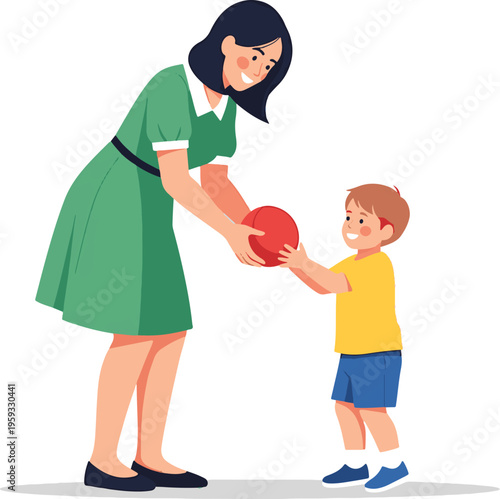 A smiling woman in a green dress passing a red ball to a happy young boy in a yellow shirt.