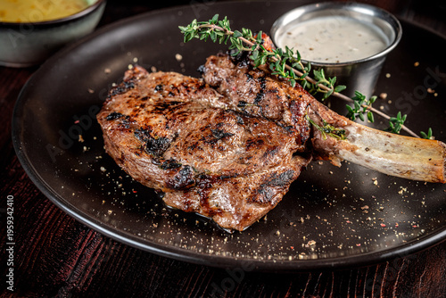 Juicy grilled bone in steak with creamy sauce
