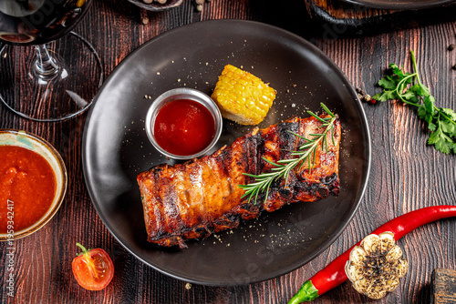 Photos Top view grilled pork ribs with sauce and corn