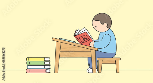 Boy sitting at desk reading book.