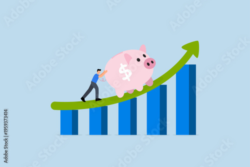 investment profit, Wealthy entrepreneur propels large piggy bank along upward trending graph and chart