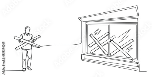 Man holding wooden planks for boarding up a window, symbolizing urgent protective measures, home security, and preparedness for residential safety and renovation projects.