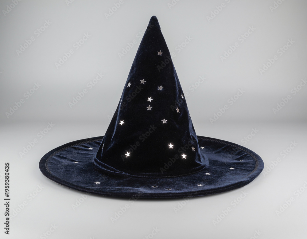 Fototapeta premium Dark Navy Blue Velvet Wizard Hat with Silver Stars on Grey Background – Magical Fantasy Object