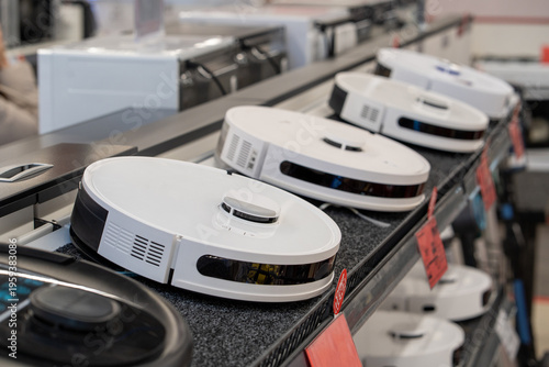 Robot Vacuum Cleaners Displayed On Retail Store Shelf. A modern robotic vacuum cleaner. Sleek design and advanced features highlight the evolution of home cleaning solutions.