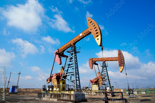 The oil pump, industrial equipment. Oil field site, oil pumps are running.