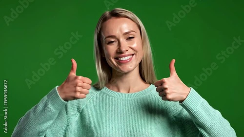 Smiling woman giving thumbs up gesture.