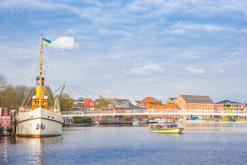 Historic steamship Prince Henry and modern bridge in the harbor of Leer, Germany
