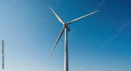 Majestic wind turbine dominates the expansive blue sky highlighting renewable energy and a sustainable future in Romania
