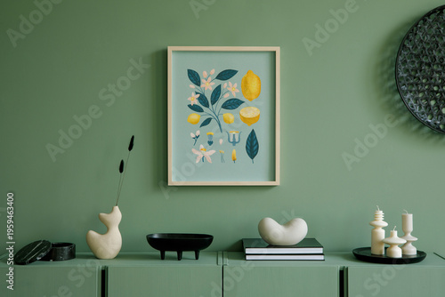 Stylish composition of modern living room interior. Mock up poster frame, wooden eucalyptus commode and creative personal accessories. Eucalyptus green wall. Home staging. Template. Copy space.