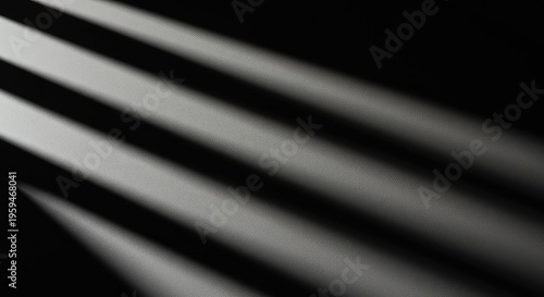 Strong, geometric shadow patterns stretch across a textured surface, creating an elegant, high-contrast abstract composition, contrast, form, composition