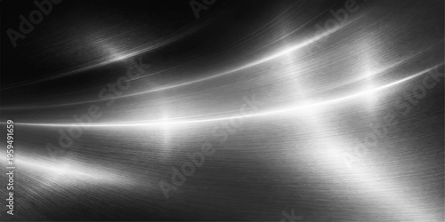 A polished silver stainless steel plate features a brushed metal texture and a shiny aluminium surface illuminated by a dark grey spotlight reflection for an abstract metallic background design