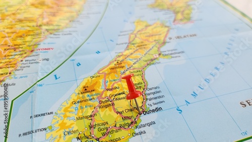 View of Dunedin, is the second-most populous city in the South Island of New Zealand, on a geographical map of Australia and New Zealand, marked with red push pin