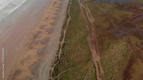 Drone glides smoothly over serene coastal landscape, revealing natural beauty and tranquility, perfect for relaxation and wellness marketing.