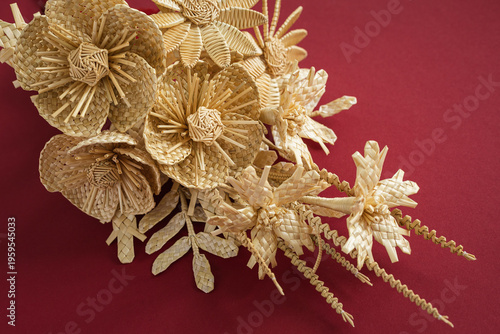 Wedding bouquet of flowers made of straw on a red background