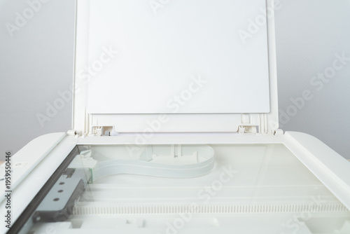 Quadro su tela Open flatbed scanner with exposed glass platen and raised lid in a clean modern office, ideal for document scanning, copying and digital archiving, close-up of the empty scanning bed and mechanism