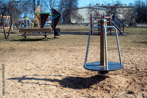 Kids have fun on playground equipment in a park while enjoying a clear sunny day.