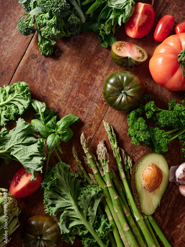 Colorful flat lay of healthy vegetables on rustic wooden background for vegan meal preparation