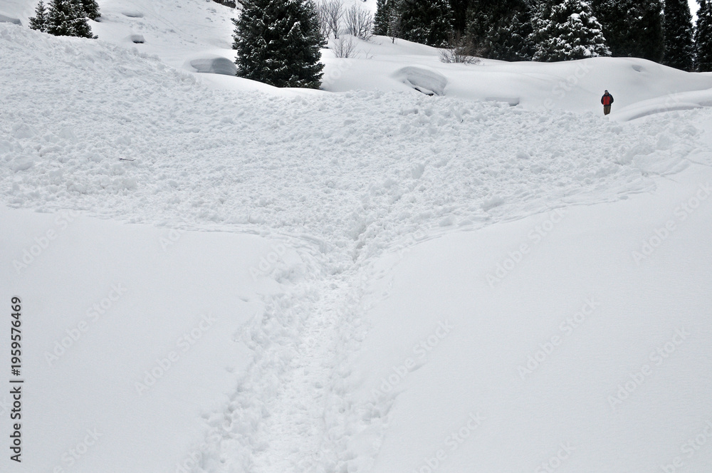Fototapeta premium Huge avalanche debris and snow mass on the road to Mynzhylky in the mountains near Almaty