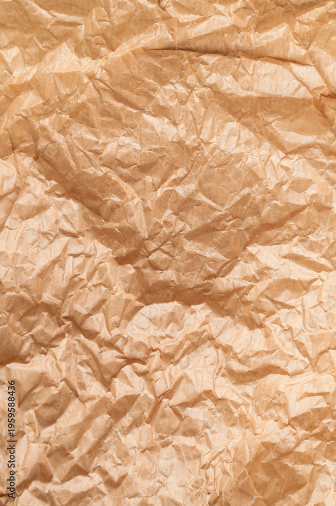 Obraz premium Texture of crumpled brown paper. Baking paper or vintage aged parchment, abstract background. Wallpaper for writing text and lettering. Backdrop for your design