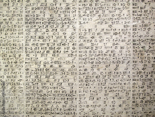 Ancient Assyrian cuneiform script carved stone; a high-detail Mesopotamian background featuring authentic wedge-shaped writing and archaeological historical inscriptions, history stock photo