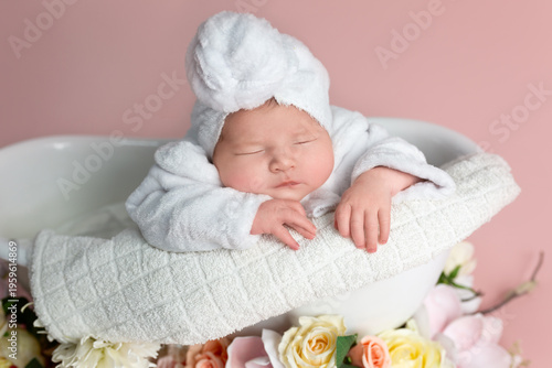 Newborn Baby Sleeping Peacefully in Bathtub with Spa Towel