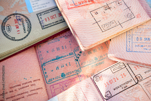 overlapping pages reveal stamps, colorful entry exit stamps Austria, Montenegro, Russia and China, international travel, border control, identity verification, travel security, safety crossing point